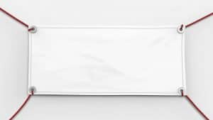 A blank white banner is suspended by four red ropes, one at each corner. The banner is slightly wrinkled and centered against a plain white background. The ropes create a rectangular frame around the banner.